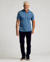 Man wearing Fiord Classic Polo with slim-fit pants and sneakers.