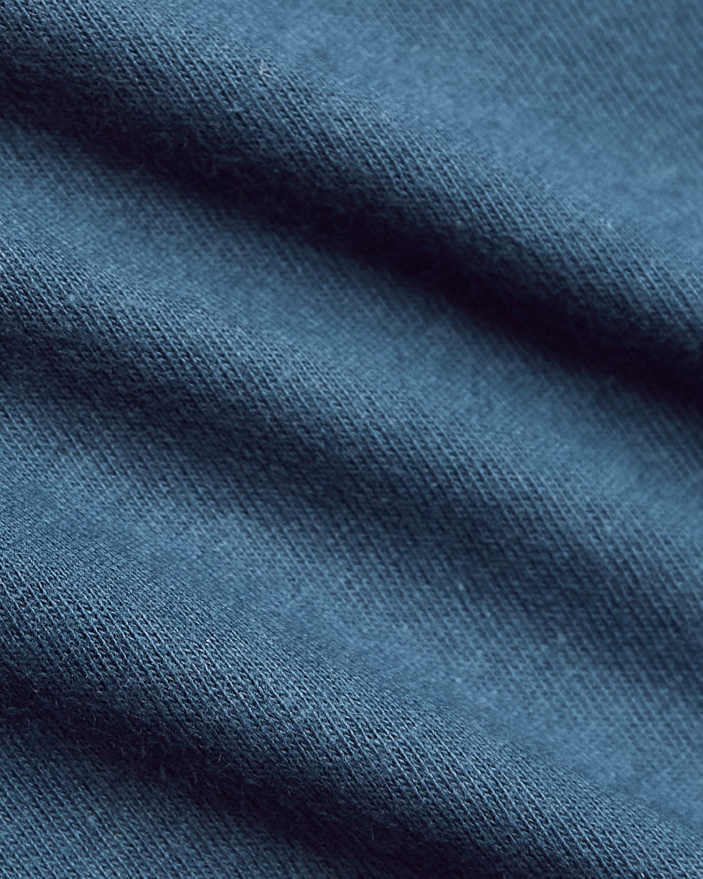 Fiord Classic Polo, soft-knit texture, close-up of blue fabric.