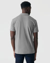 Glacier Gray Classic Polo worn with dark blue jeans, back view.