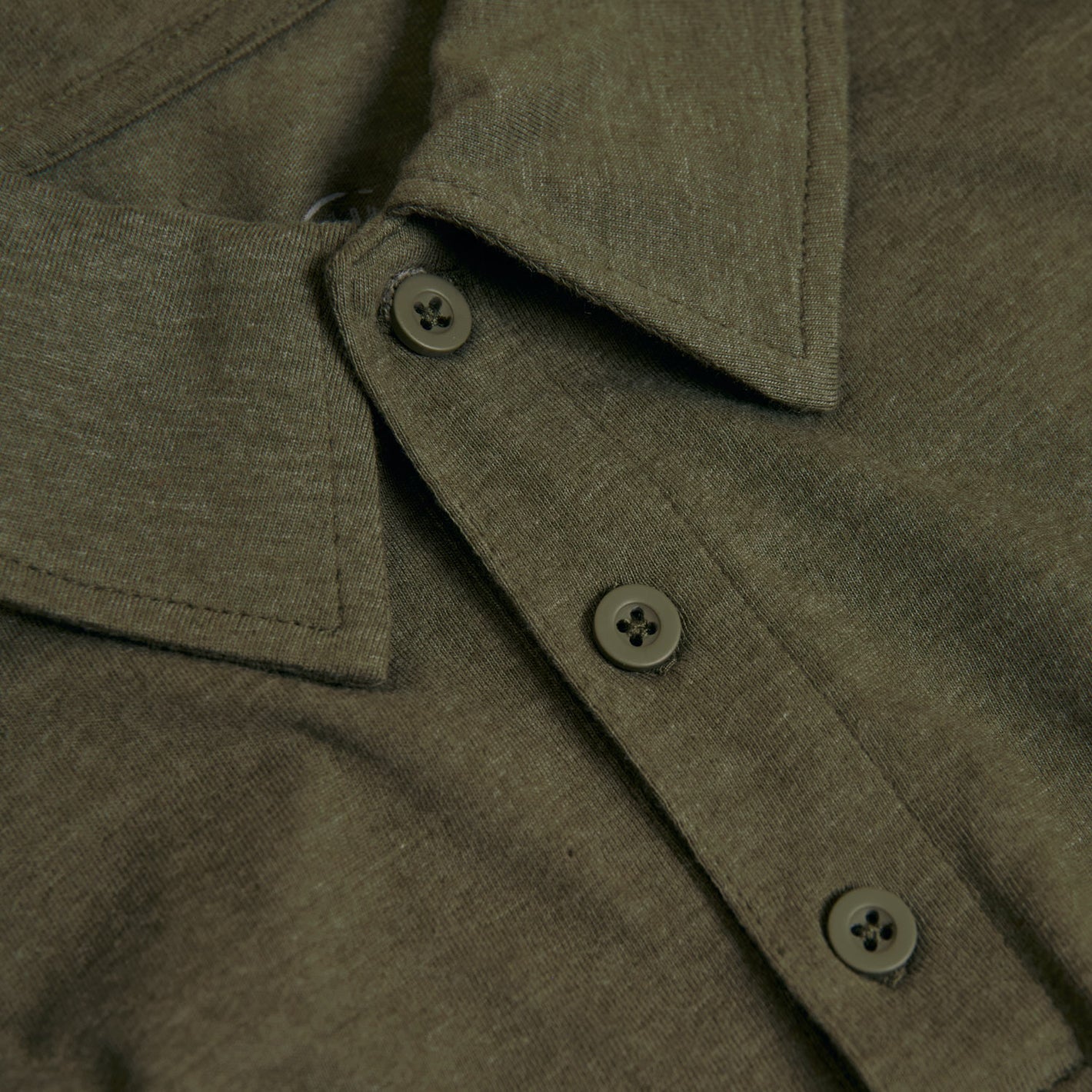 Heather Polo 3-Pack: Close-up of olive-green collared shirt with buttons.
