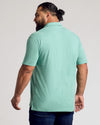 Back view of man in Light Heather Greenery Classic Polo.