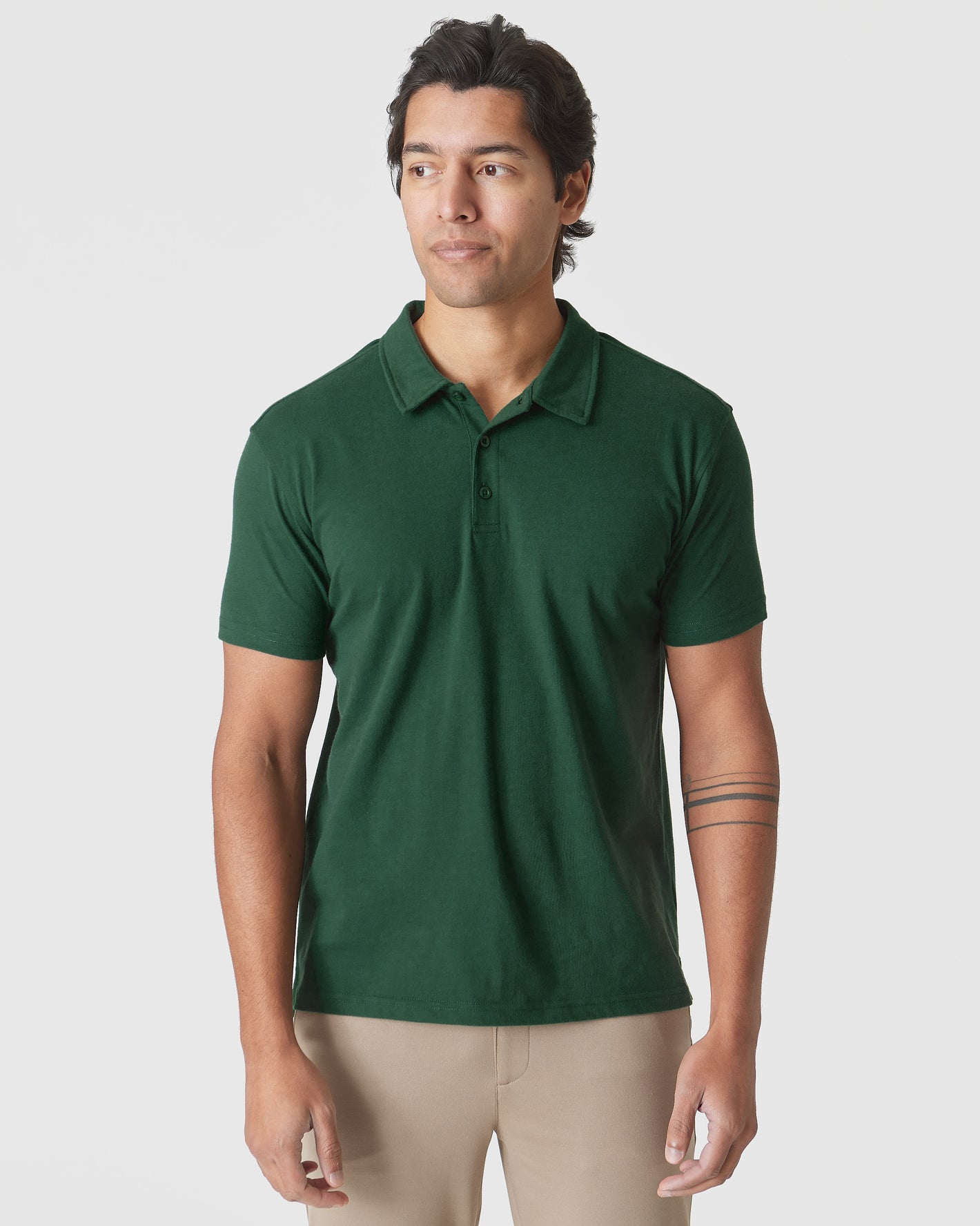 Moss Green Polo on model with beige trousers.