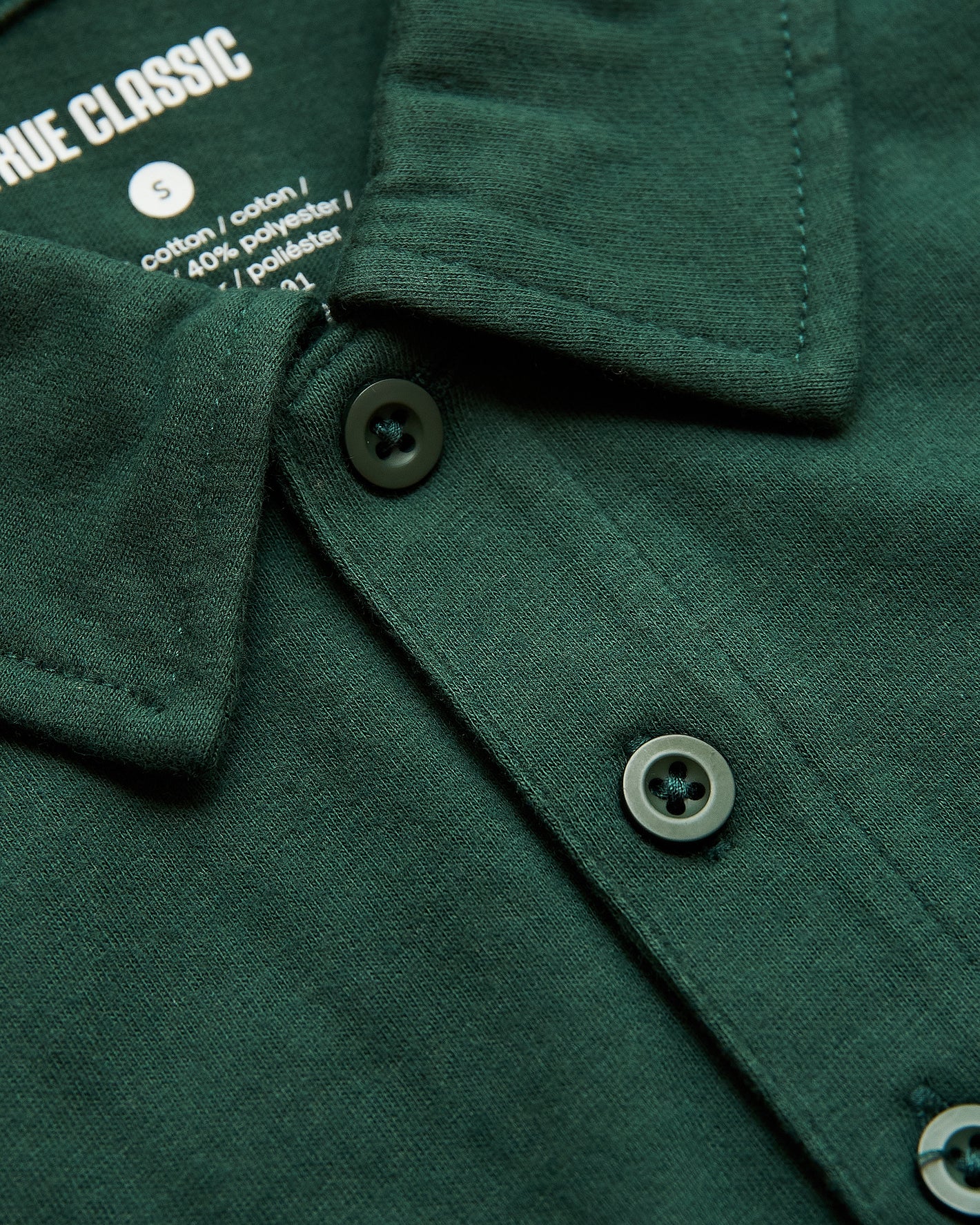 Moss Green Polo with folded collar and visible buttons.