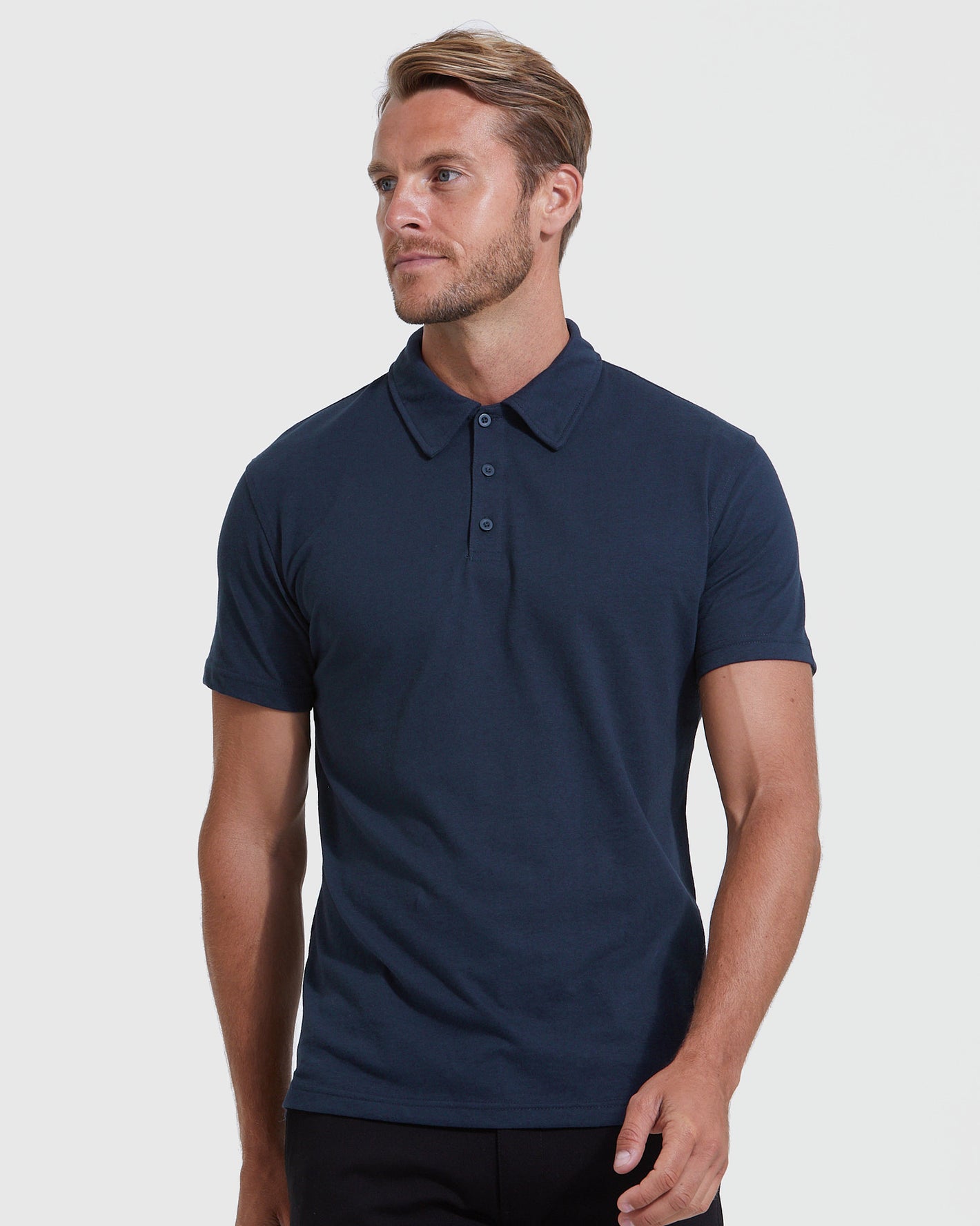 Male model wearing All Navy Short Sleeve Polo 6-Pack.