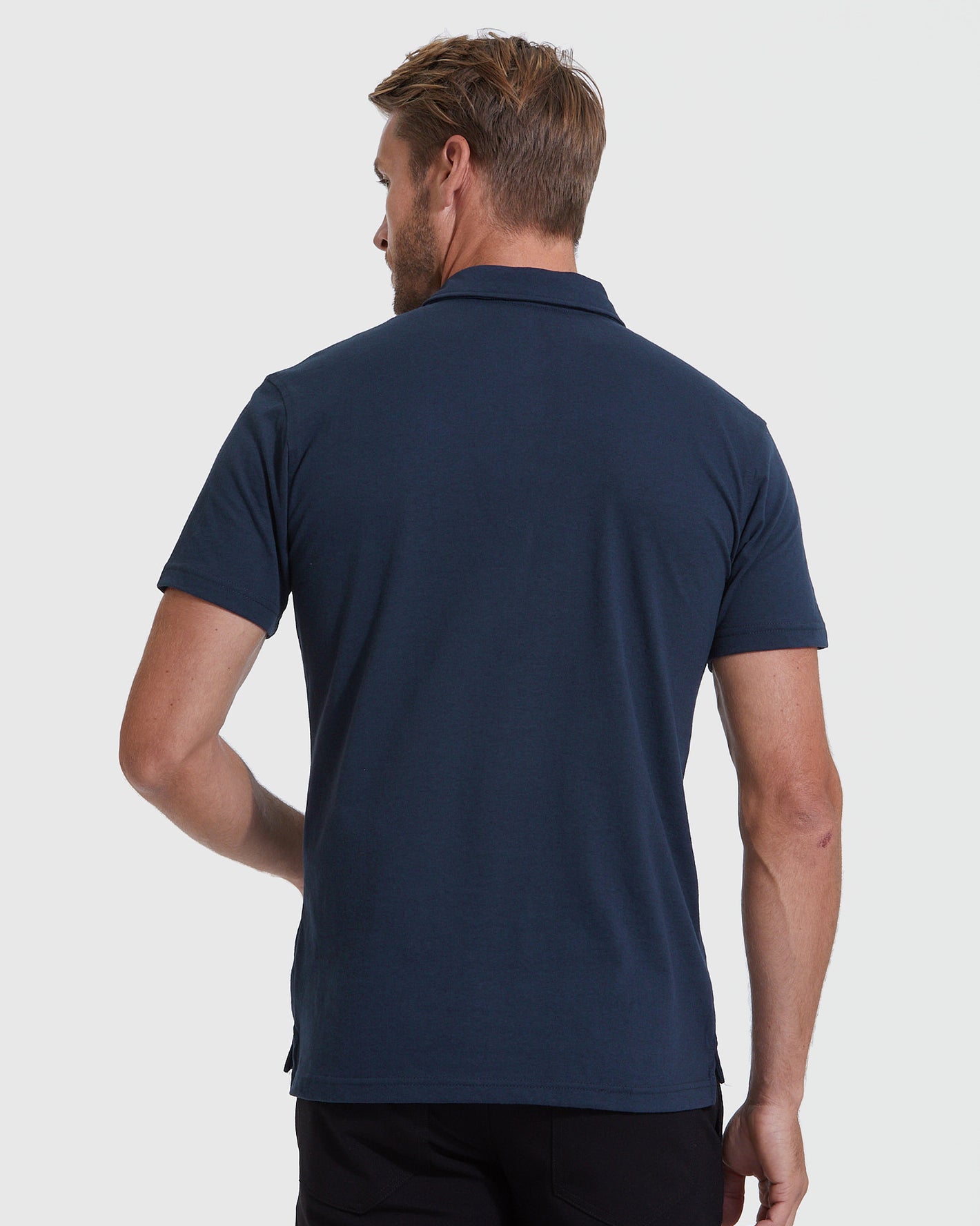 Back view of All Navy Short Sleeve Polo on model.