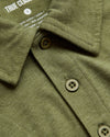 Olive Green Heather Polo with button placket and soft tag.