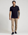 Model wears Classic Polo 6-Pack black shirt with tan trousers.