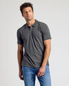Man wearing Heather Polo 3-Pack in charcoal-gray with blue jeans.