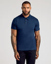 Man wearing a navy blue polo shirt against a plain background