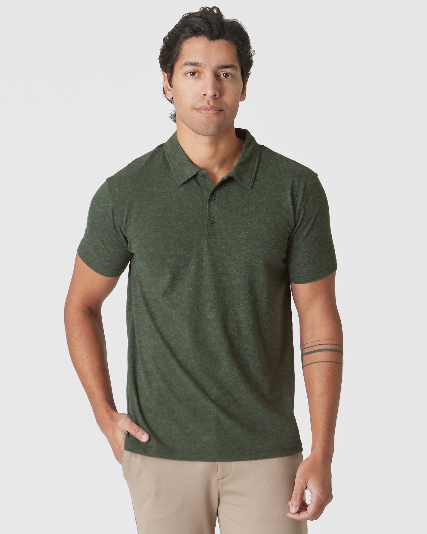 Model wearing Racing Green Heather Polo with khaki trousers.