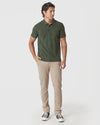 Man wearing Racing Green Heather Polo with chinos and sneakers.