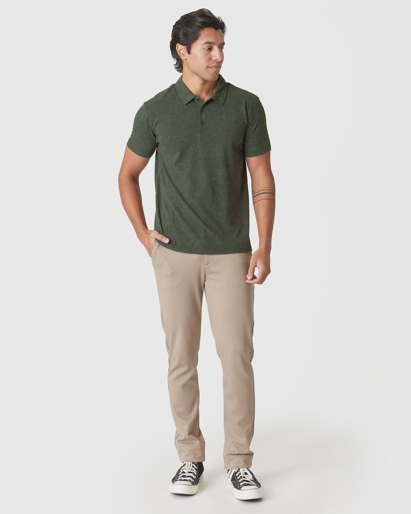 Man wearing Racing Green Heather Polo with chinos and sneakers.
