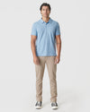 Young man wearing Sky Blue Heather Polo, showcasing its sleek, fitted design.