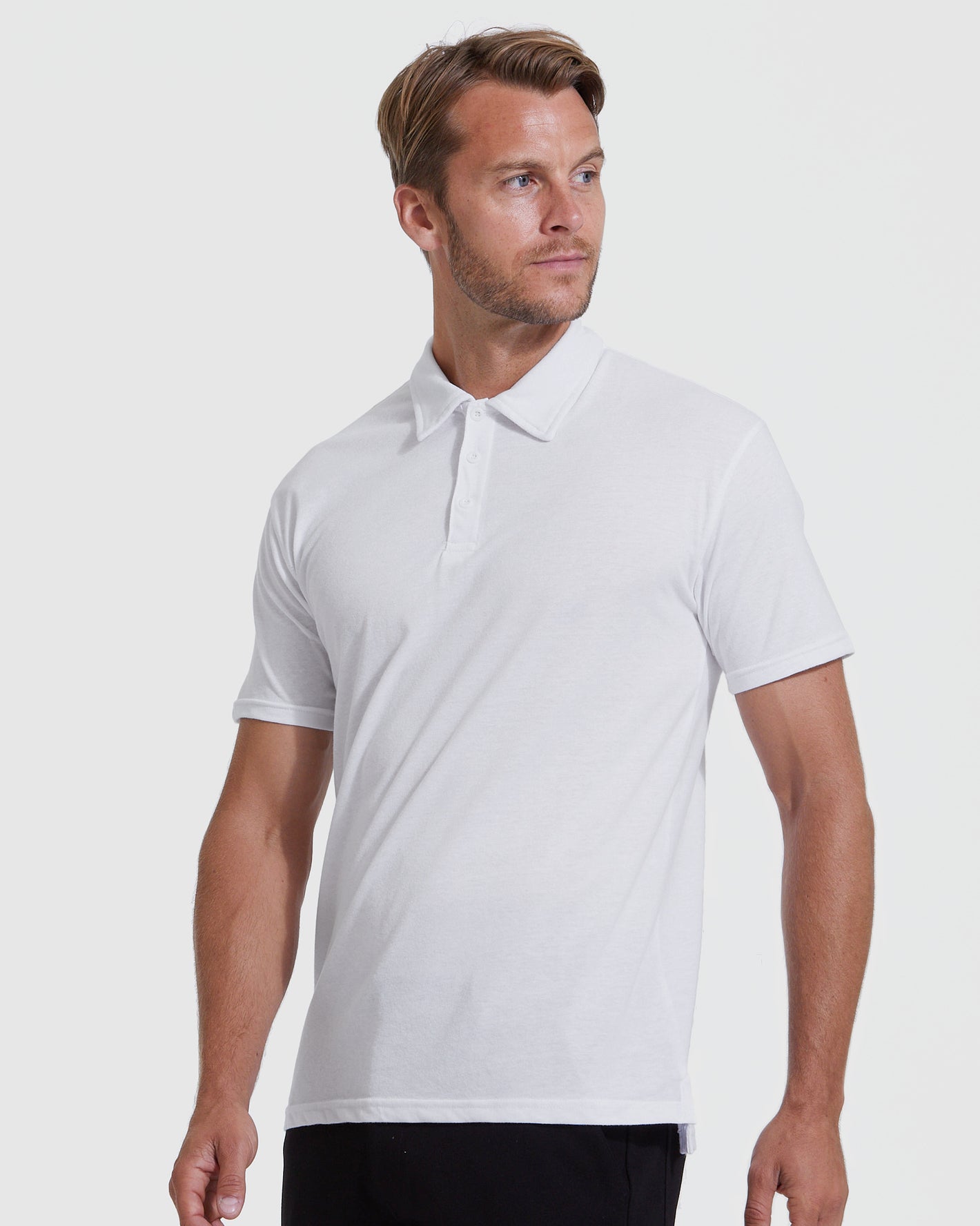 White Classic Polo 3-Pack: man in white polo, dark pants.