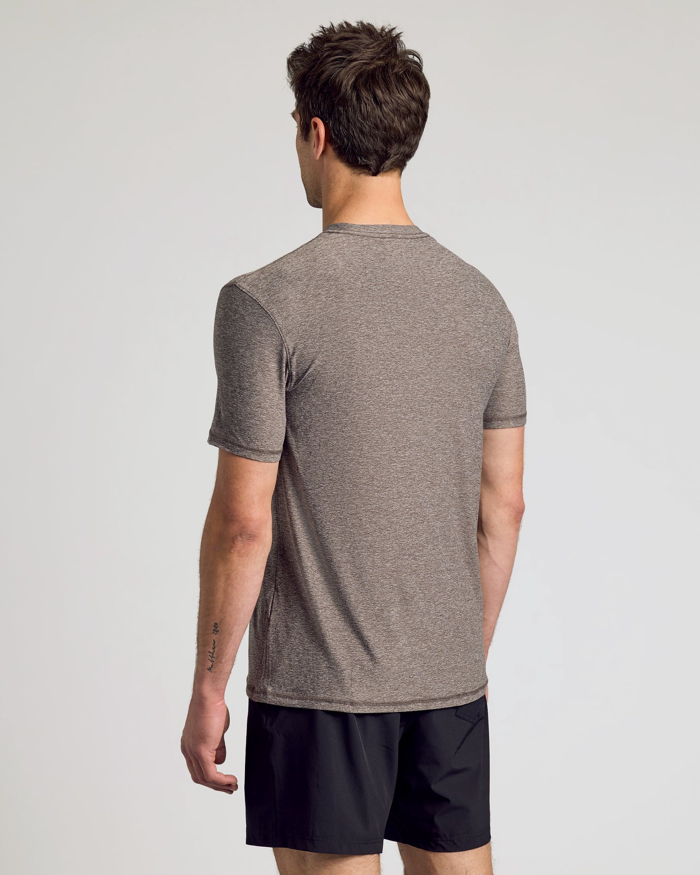Heather Cocoa Active Crew Neck Tee on man, showcasing back view.