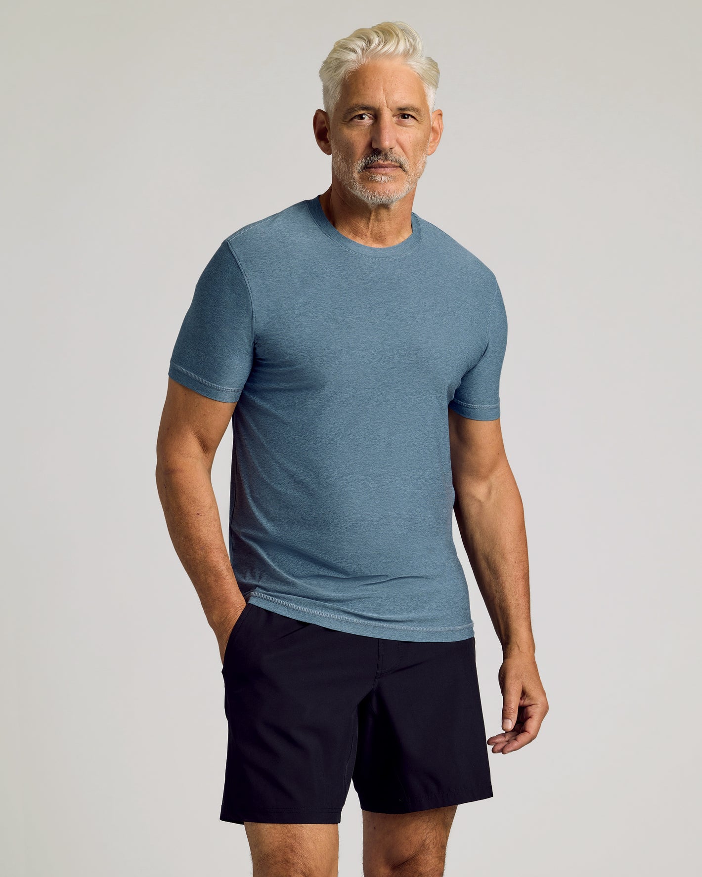 Man wearing Baltic Active Crew Neck Tee and black shorts.