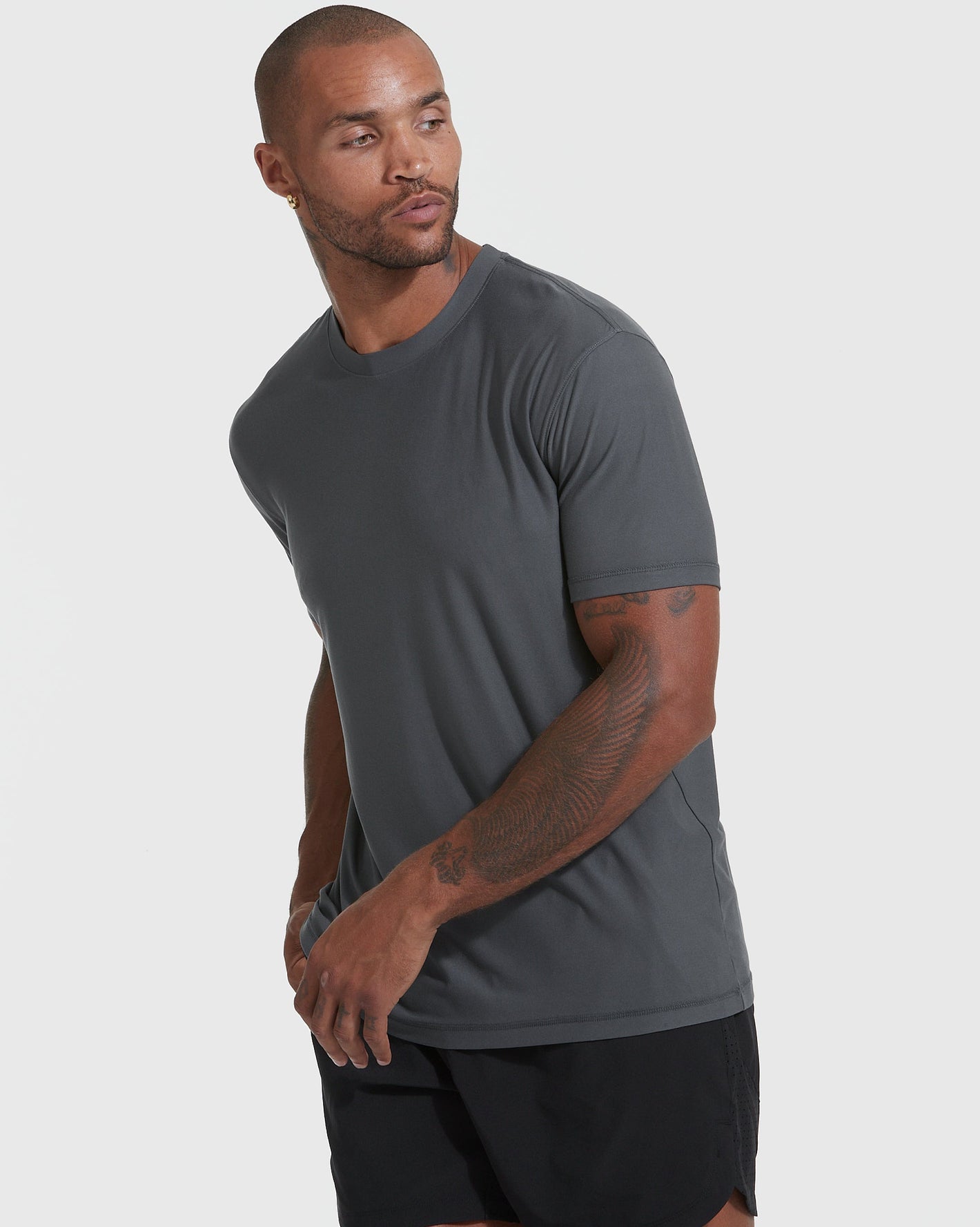 Fit male model in Midnight Active Crew 3-Pack, showcasing dark gray T-shirt.