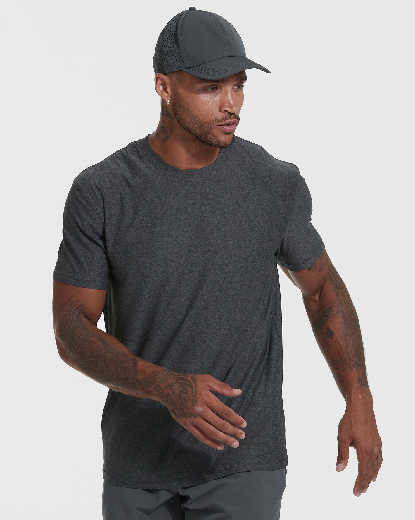 Model in charcoal-gray crew-neck tee and cap, showcasing Heather Active and Classic Crew Neck Tee 6-Pack.