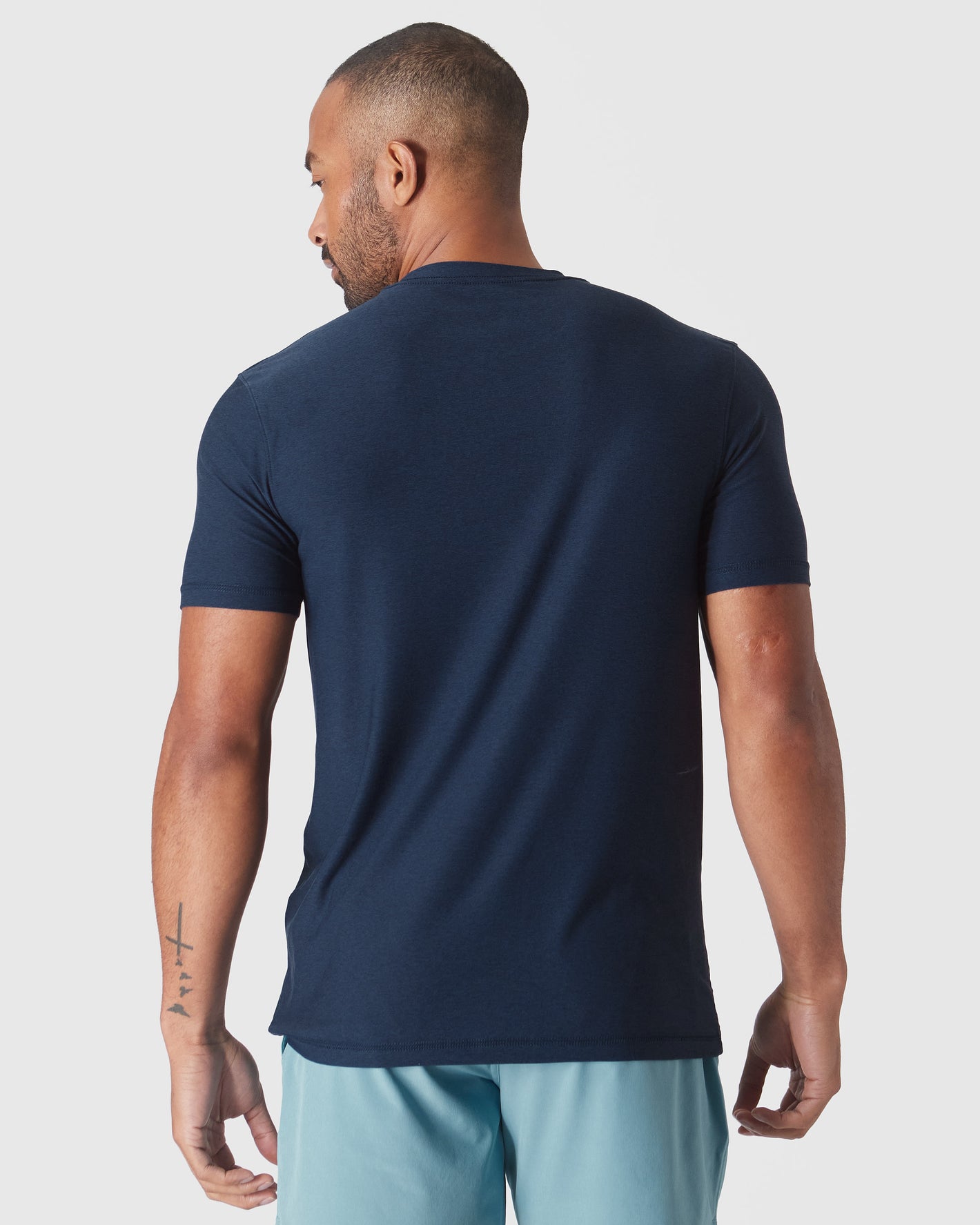 Man wearing Dark Heather Cadet Active Crew Neck Tee, back view.