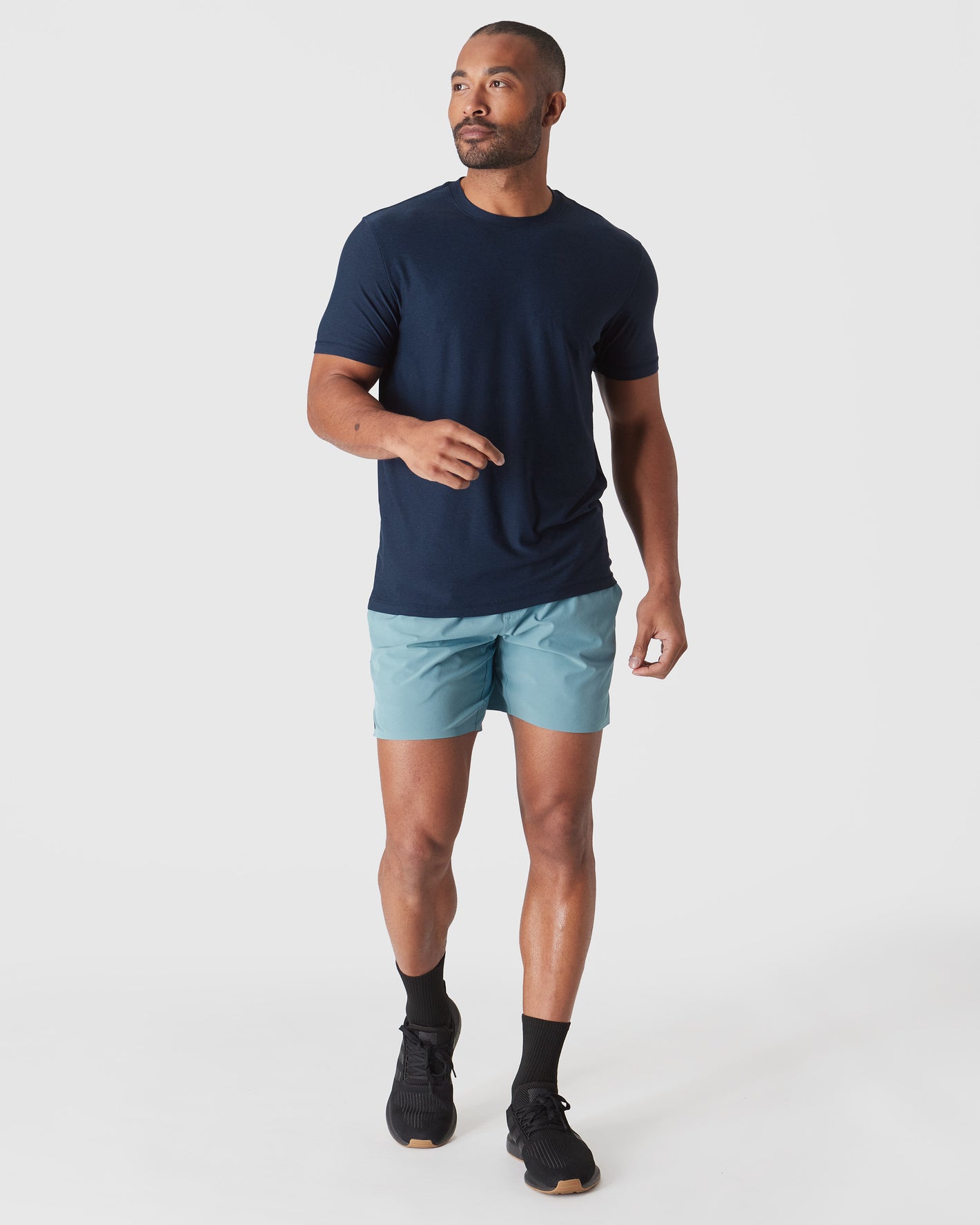 Model in Dark Heather Cadet Active Crew Neck Tee mid-stride.