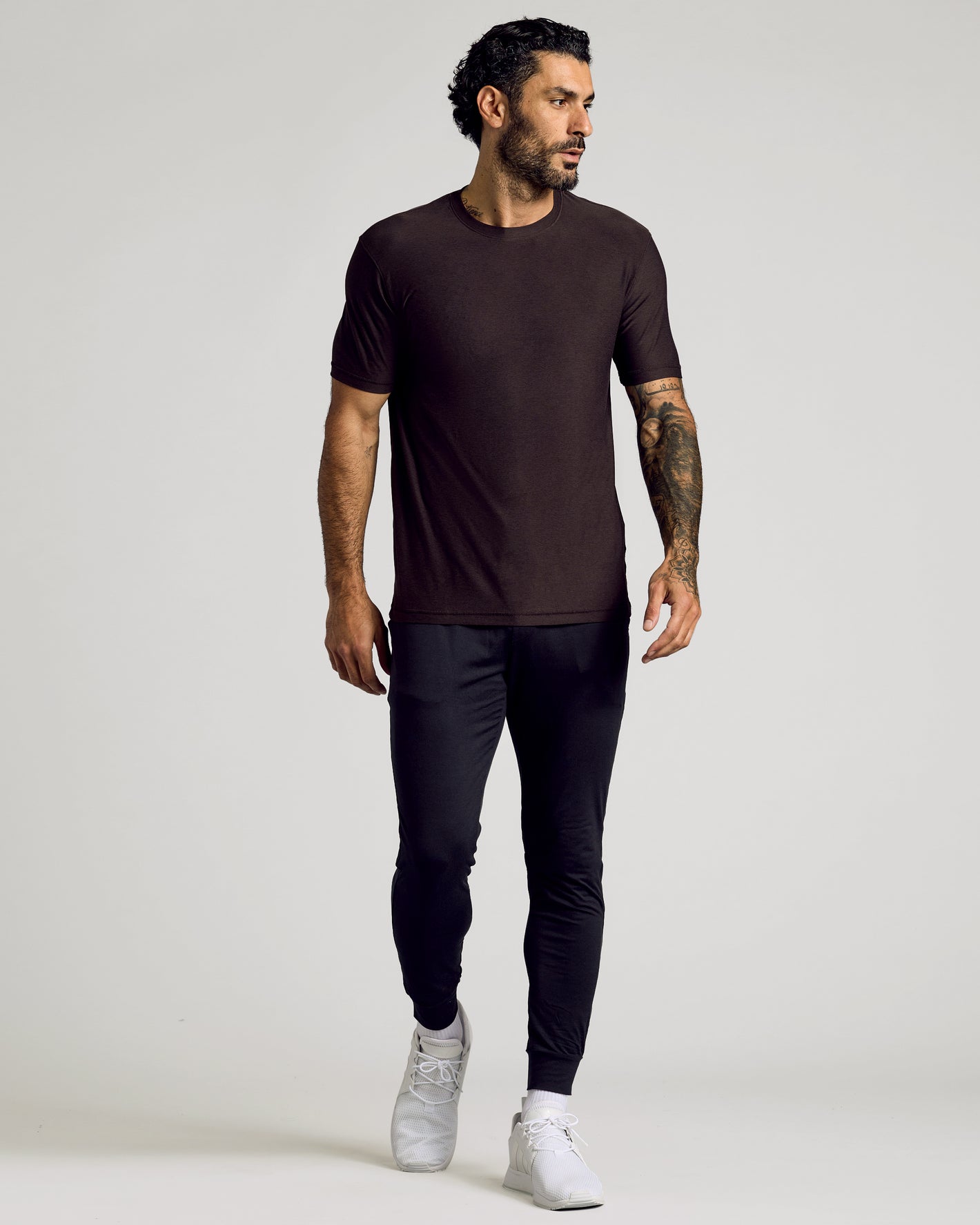 Man wearing Dark Heather Cocoa Active Crew Neck Tee with black jogger pants.
