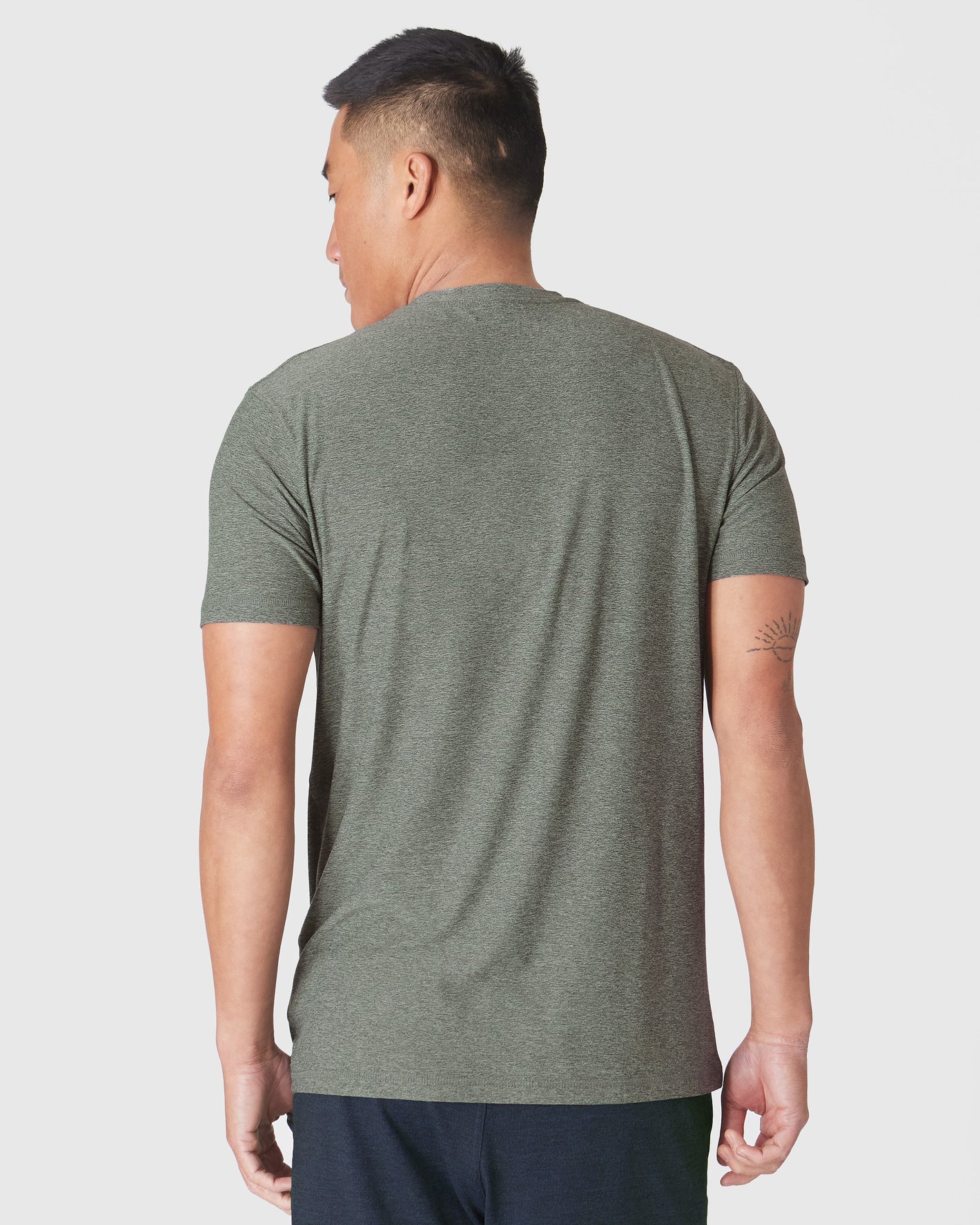 Heather Forest Short Sleeve Active Crew Neck worn, showcasing the fit and tattoo.