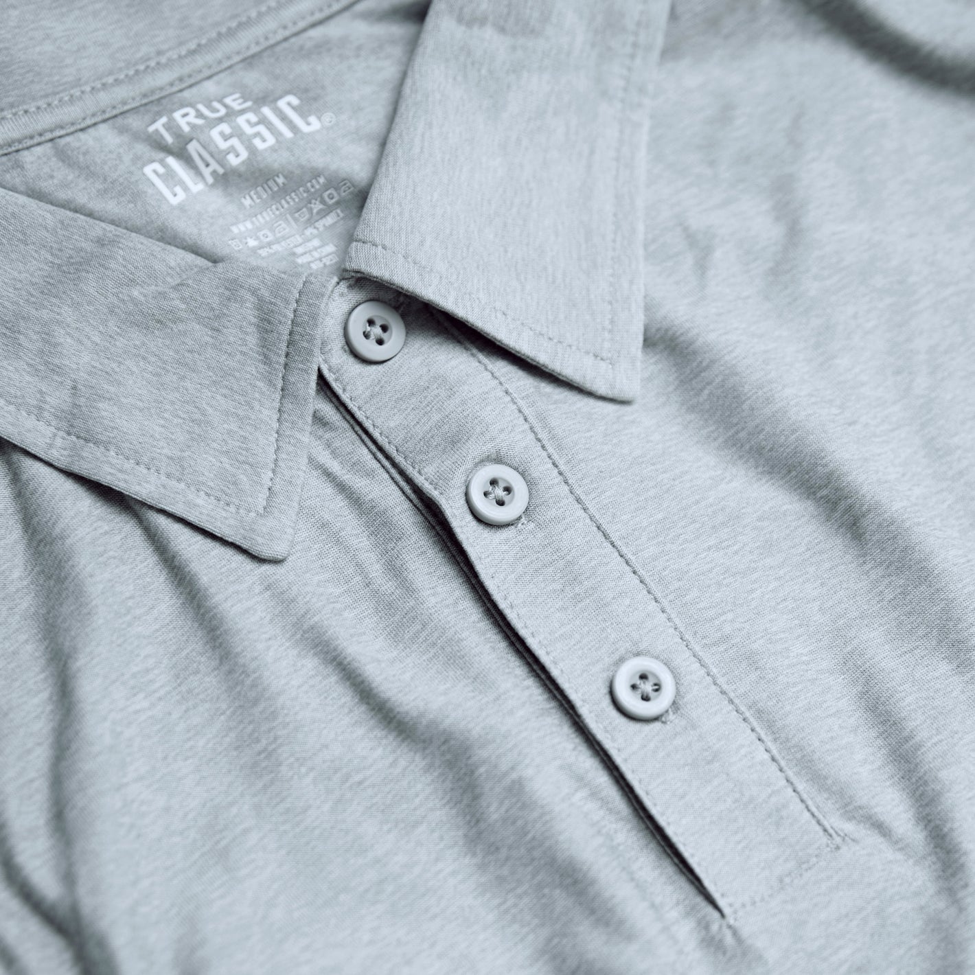 Light Heather Gray Active Polo 2.0 with three-button placket and collar.