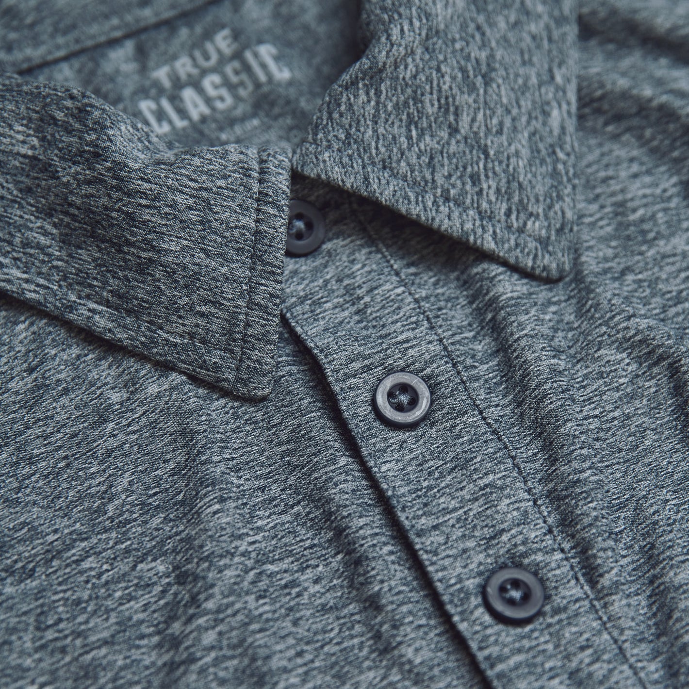 Heather Navy Active Short Sleeve Polo, textured knit, three-button placket, TRUE CLASSIC label.