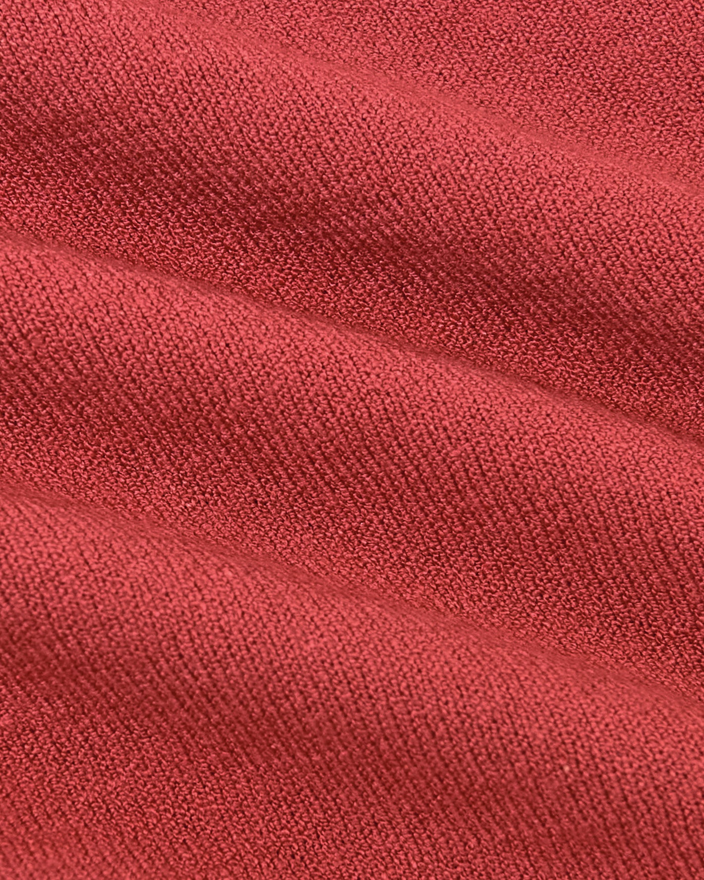 Garnet Short Sleeve Sweater Polo in textured, coral-red knit fabric.