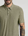 Man wearing a green polo shirt with a plain background