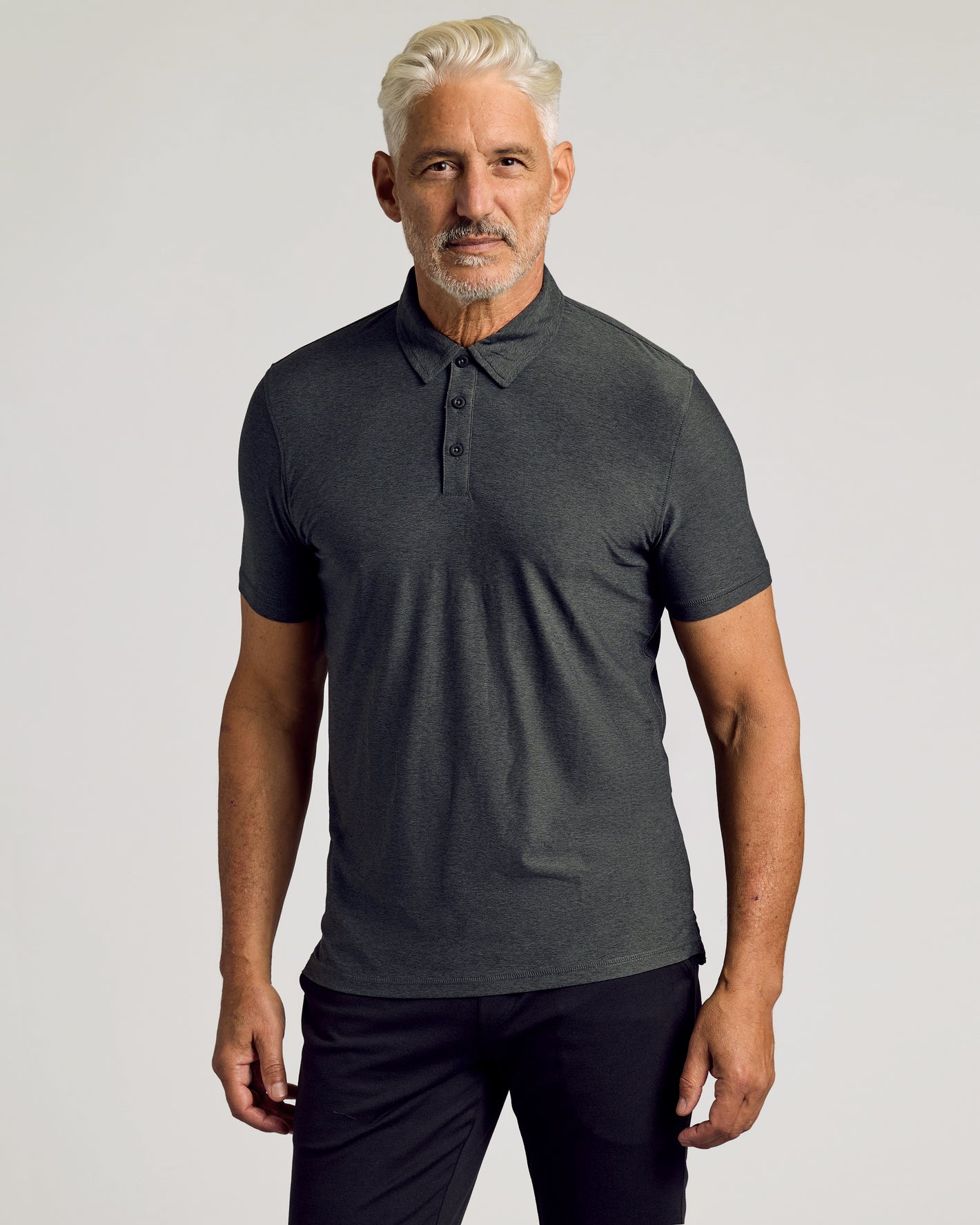 Active Polo 6-Pack: Man in fitted charcoal-gray polo, minimalist style.