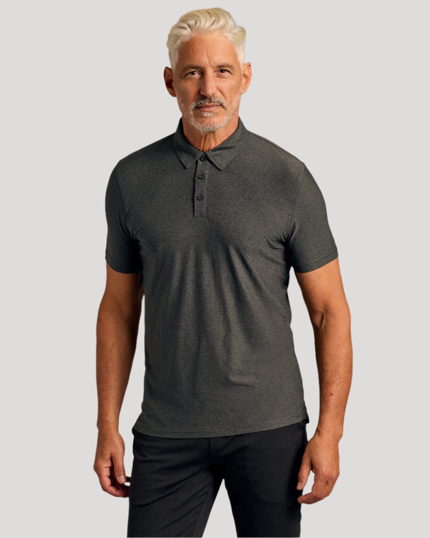 Man wearing Active Short Sleeve Polo 3-Pack in dark gray.