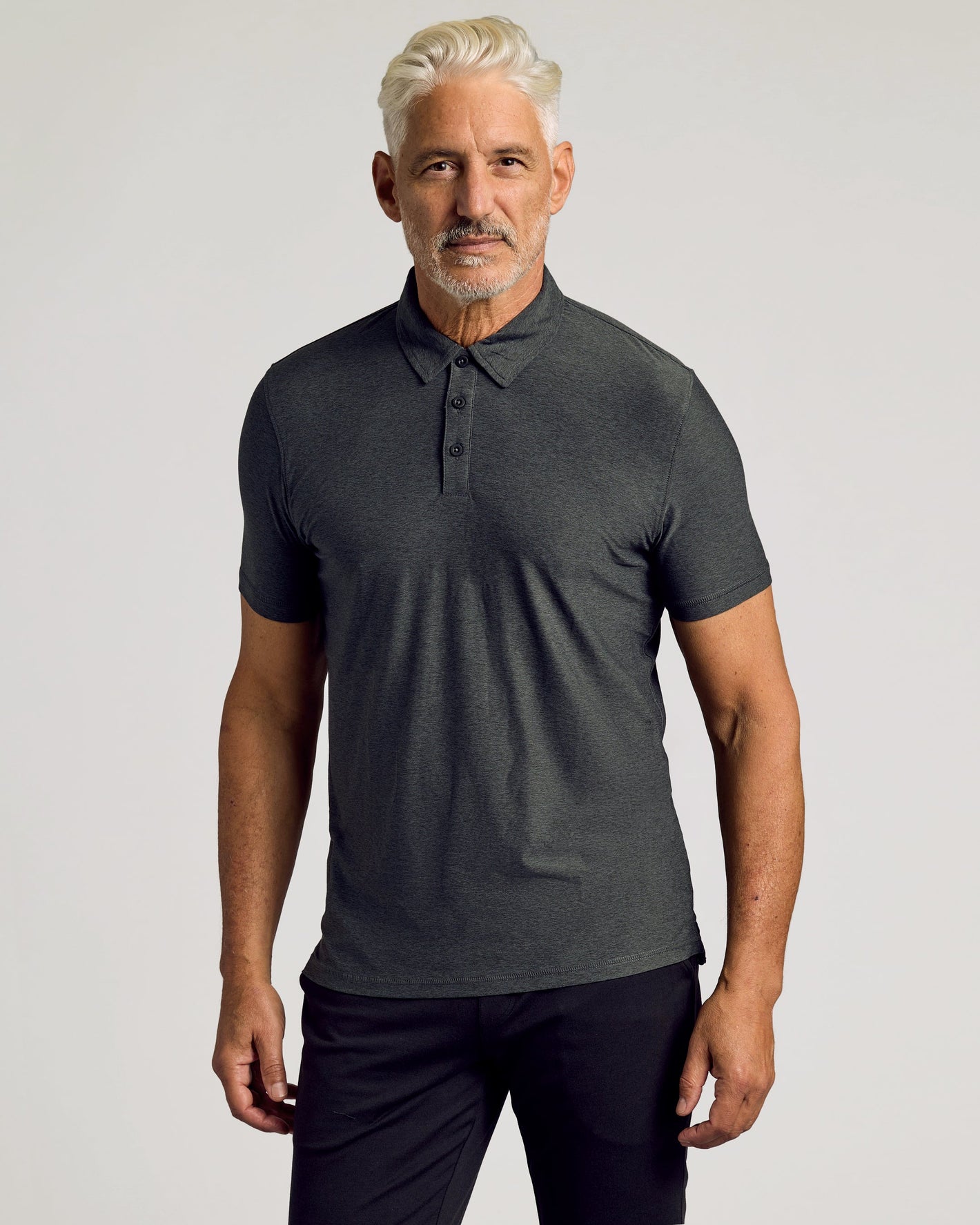 Charcoal Heather Gray Active Polo 2.0 worn by man, showcasing fit.