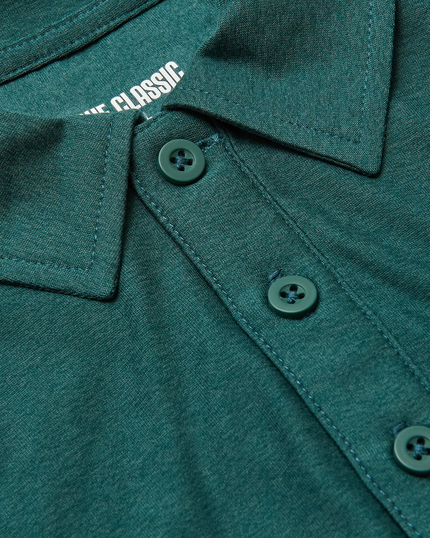 Clover Active Polo 2.0 close-up: collar, three-button placket, CLASSIC label.