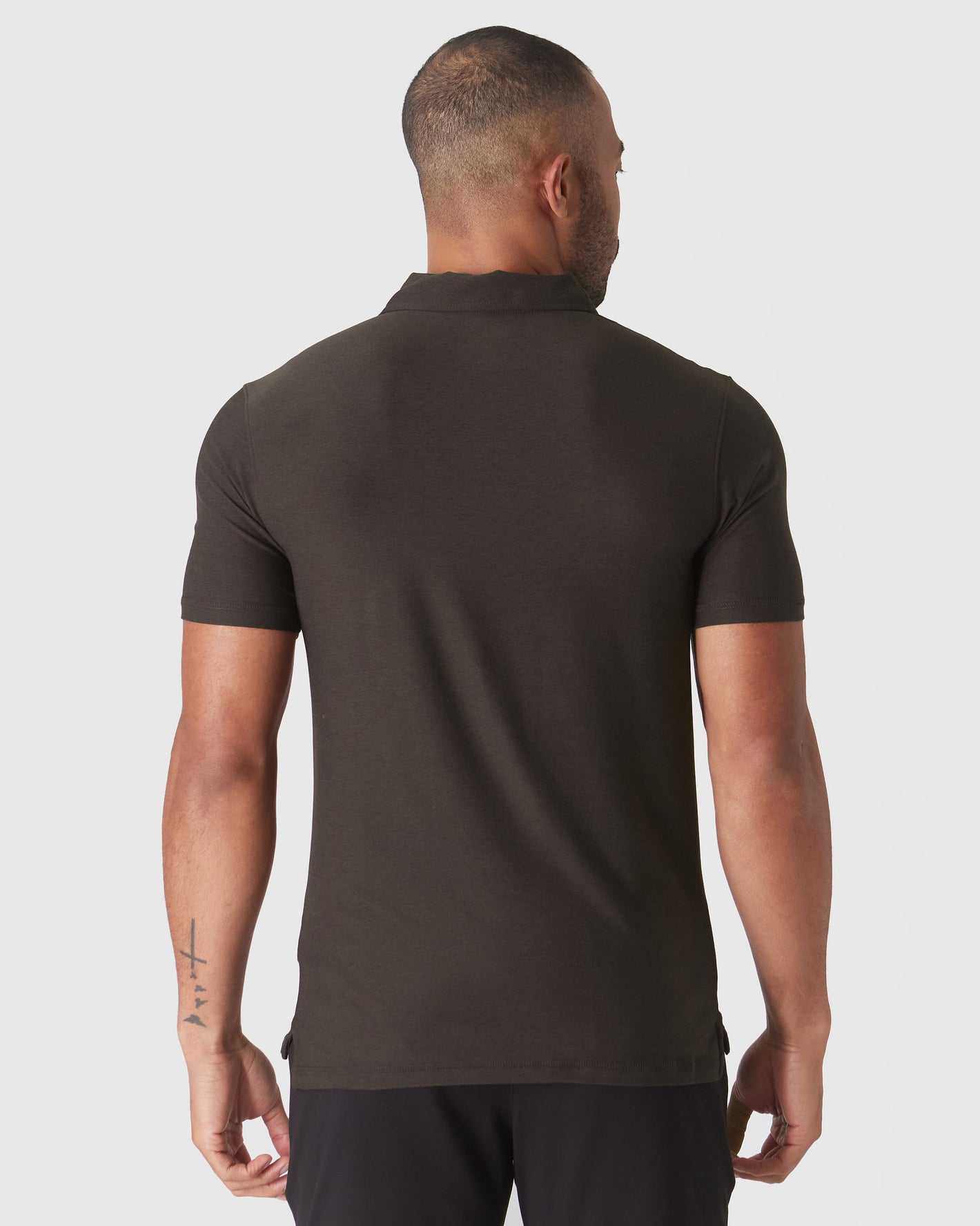 Back view of Dark Heather Cocoa Active Polo 2.0 worn by man.