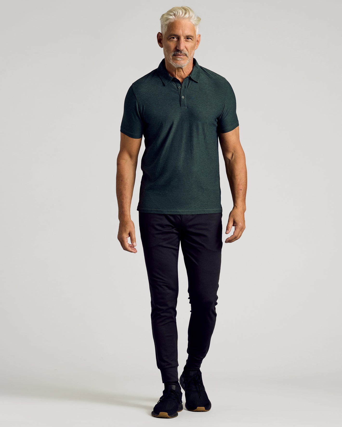 Dark Heather Forest Active Polo 2.0 worn by male model.