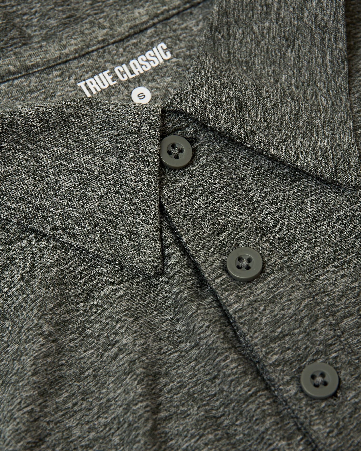 Heather Forest Active Polo 2.0, dark heather-gray, folded collar, three-button placket.