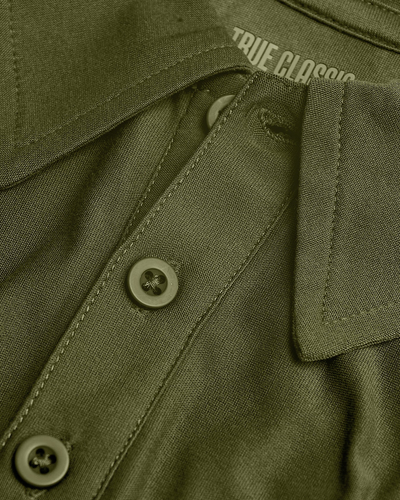 Military Green Active Polo 2.0 collar with buttons and texture.