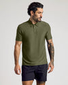 Man wearing The Staple Active Polo in olive-green, showcasing its athletic fit.