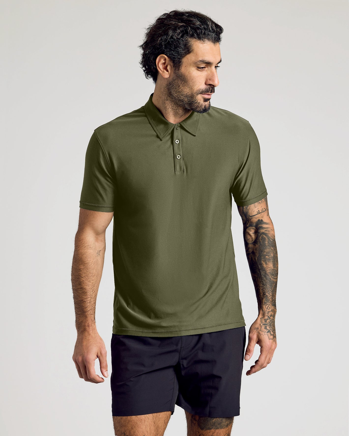 Model in olive Active Polo 10-Pack, showcasing athletic fit and style.