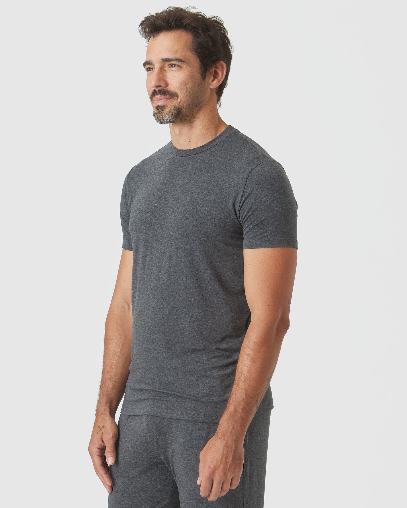 Charcoal Heather Gray Short Sleeve Loungewear Tee on bearded man in profile.