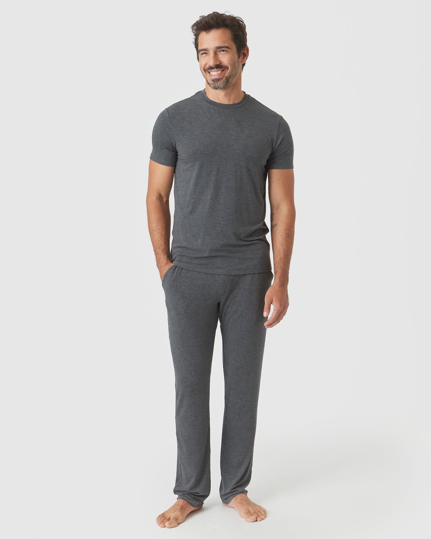 Man in Charcoal Heather Gray Short Sleeve Loungewear Tee, smiling, relaxed.
