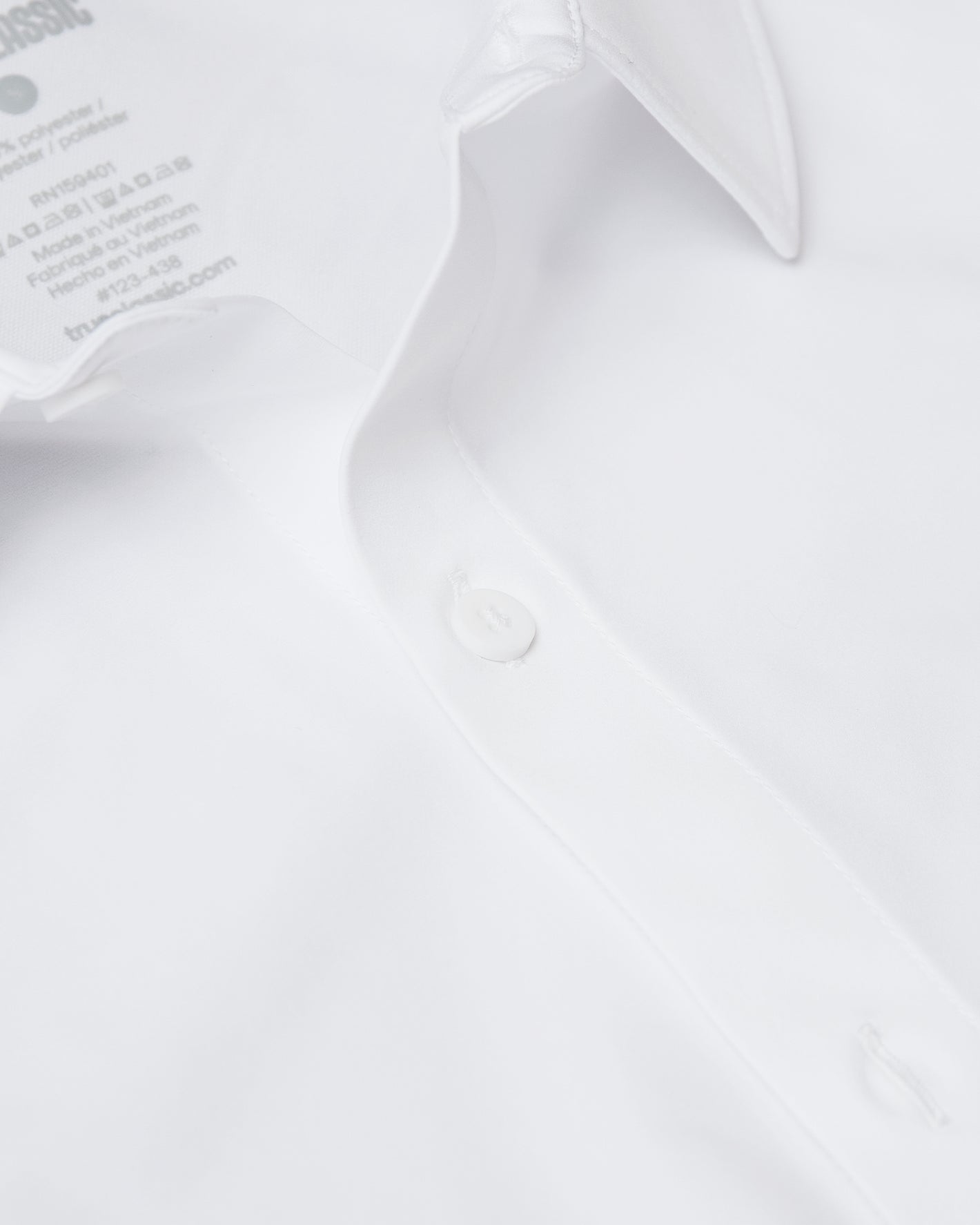 White Short Sleeve Commuter Shirt close-up, highlighting collar and button detail.