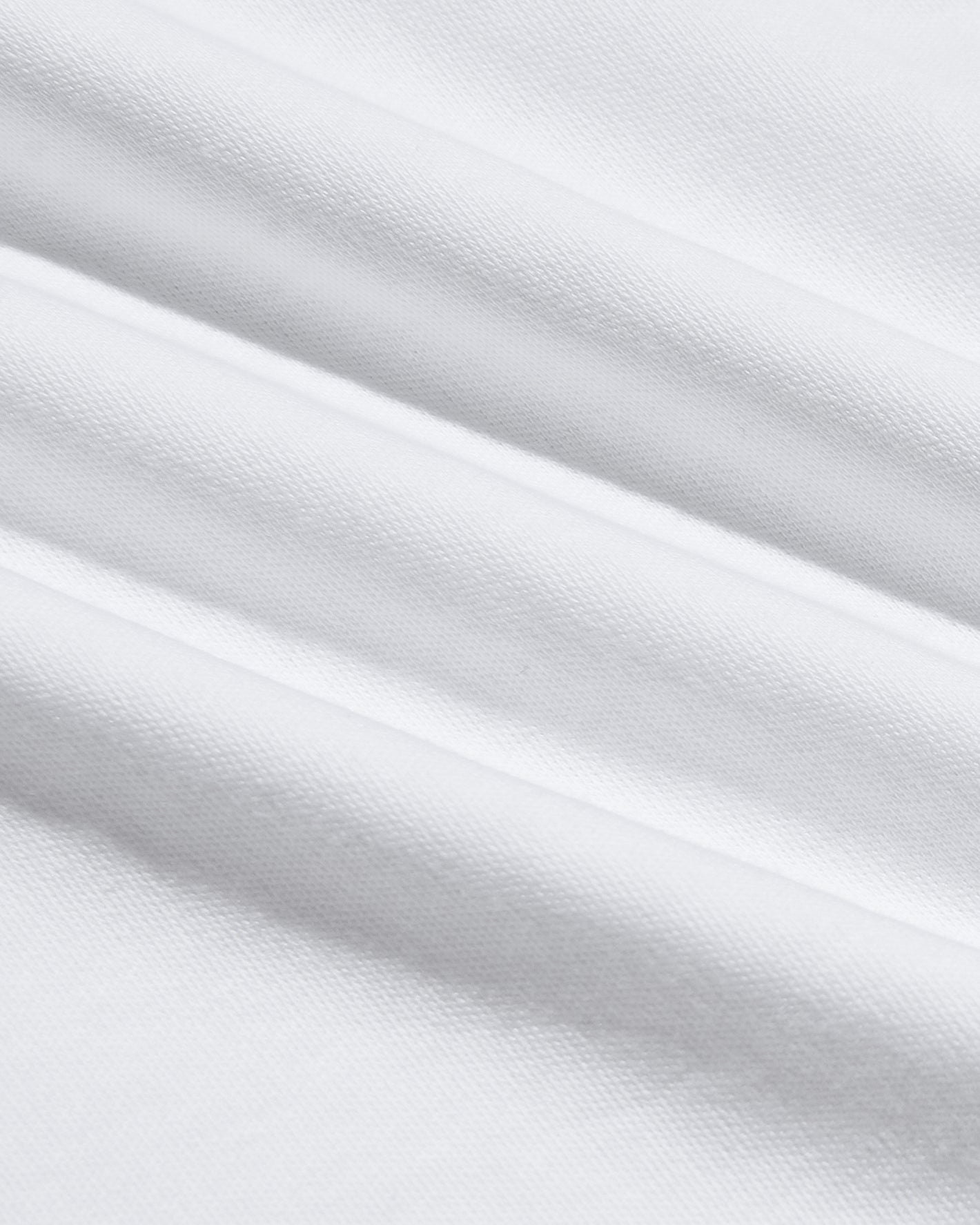 White Premium Pima Crew Curved Hem, close-up of silky, draped cotton fabric.