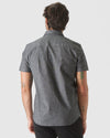 Back view of man in Black Wash Short Sleeve Stretch Chambray Shirt.