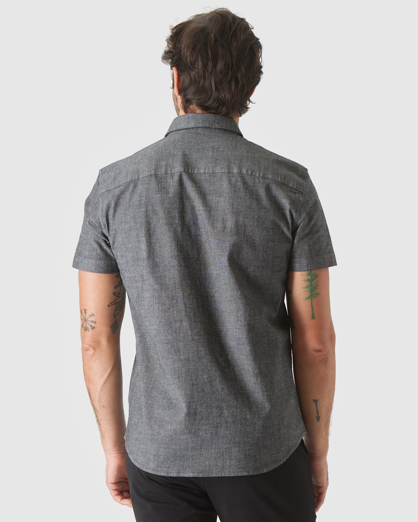 Back view of man in Black Wash Short Sleeve Stretch Chambray Shirt.