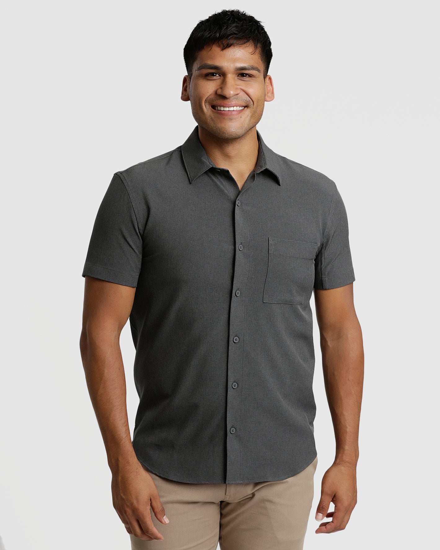 Man wearing Charcoal Heather Gray Short Sleeve Ripstop Commuter Shirt, smiling.