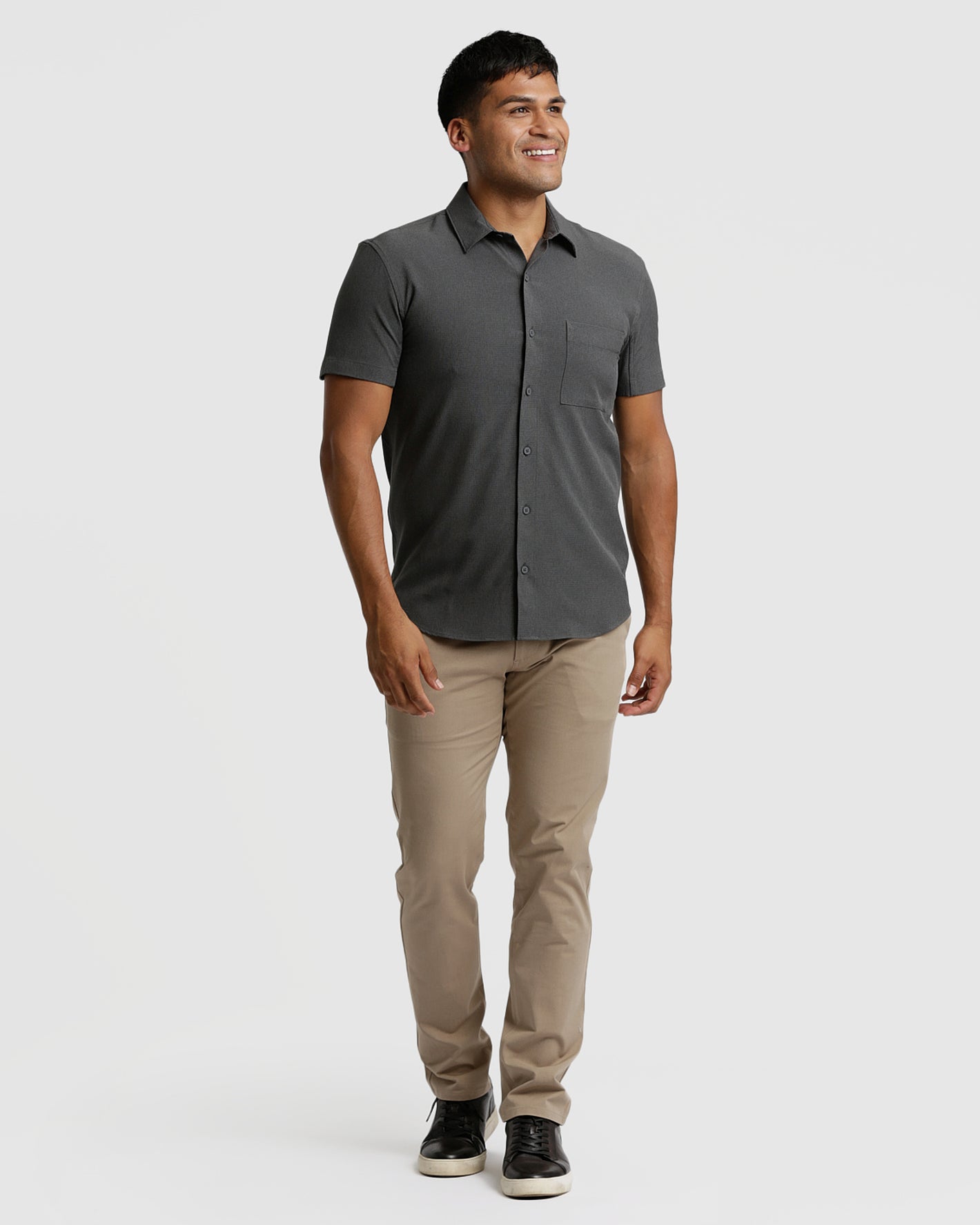 Model wearing Charcoal Heather Gray Short Sleeve Ripstop Commuter Shirt, tan pants.