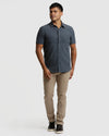 Man wearing Heather Short Sleeve Ripstop Commuter Shirt, dark gray, slim khaki pants.