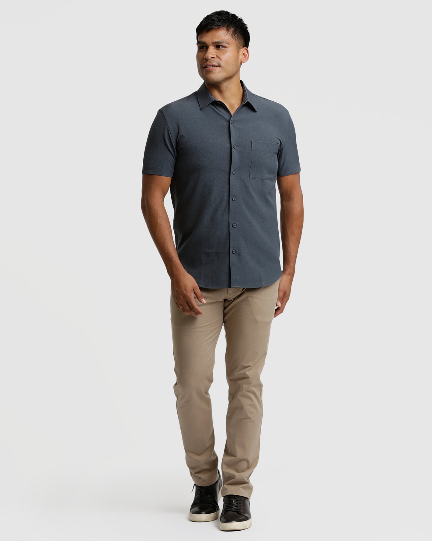 Model in Short Sleeve Ripstop Commuter Shirt, charcoal-grey, with khaki chinos.